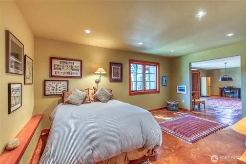 a bedroom with a large bed and a window