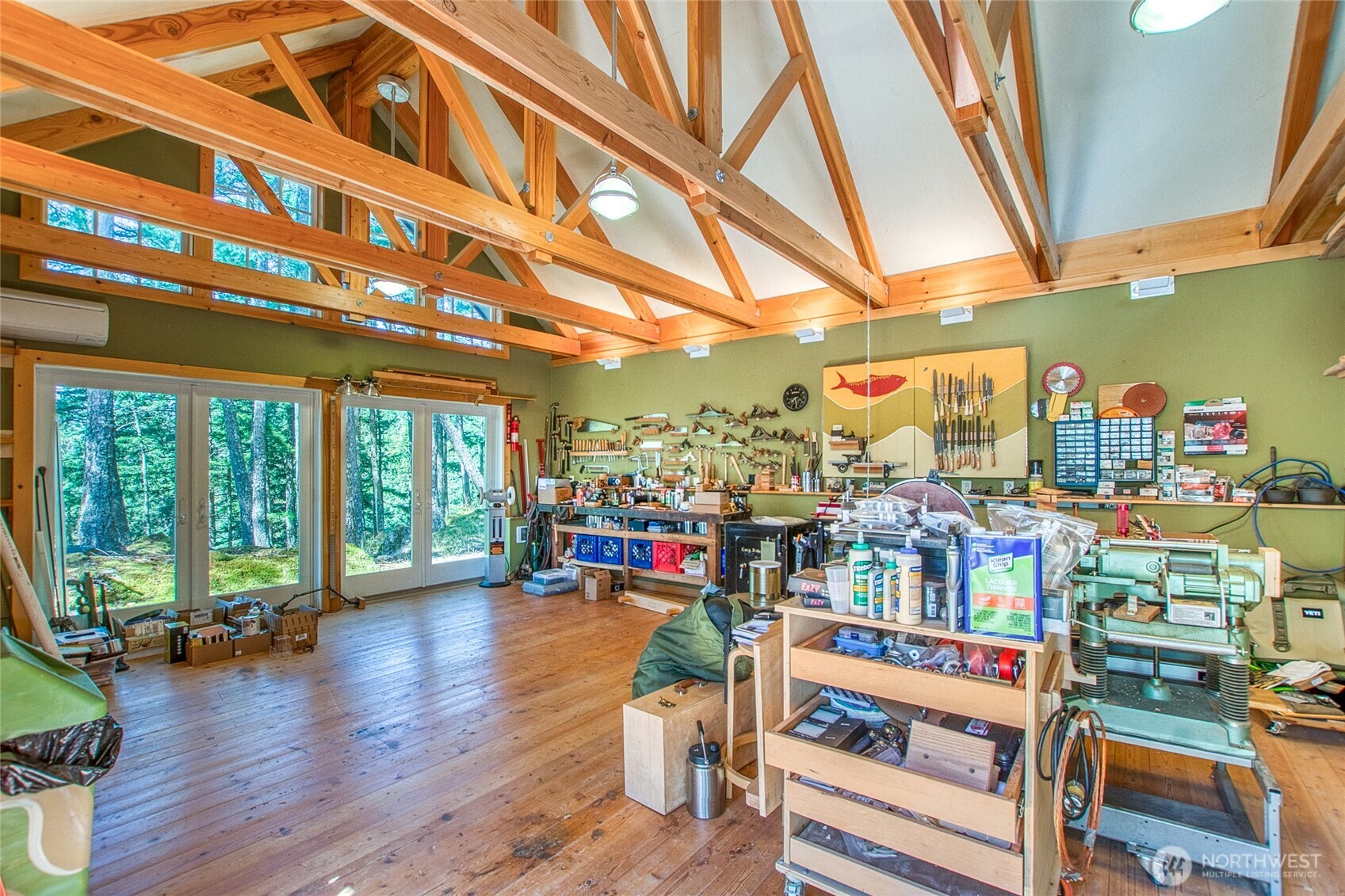 64 Hammond Lane Orcas Island, WA 98245 - Photo 34 of 39 a room with lots of wooden furniture and a floor to ceiling window
