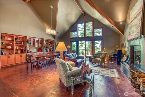 a living room filled with furniture hardwood floor and a large window