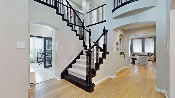 a view of entryway and hall with wooden floor