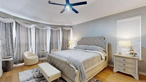 a spacious bedroom with a bed and a dresser