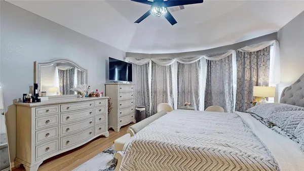 a bedroom with a large bed and a dresser
