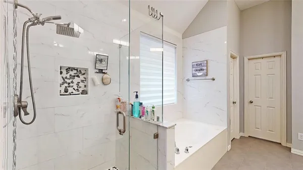 a bathroom with a tub sink and shower