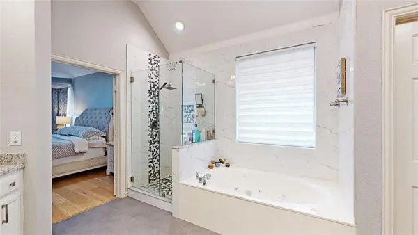 a bathroom with a bathtub and a shower