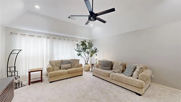 a living room with furniture and a potted plant
