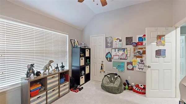 a bedroom with furniture and a book shelf