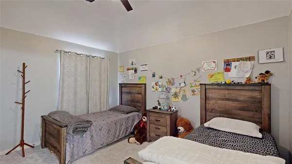 a bedroom with a bed and a dresser in it