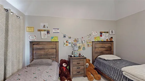 a bedroom with a bed and a dresser in it