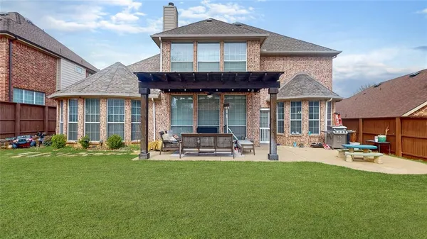 a front view of a house with patio and garden