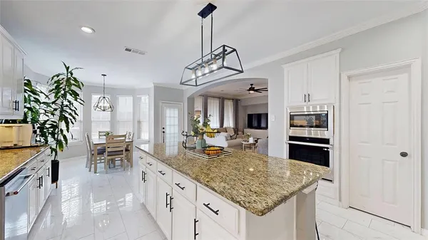 a kitchen with stainless steel appliances granite countertop a stove oven and a refrigerator