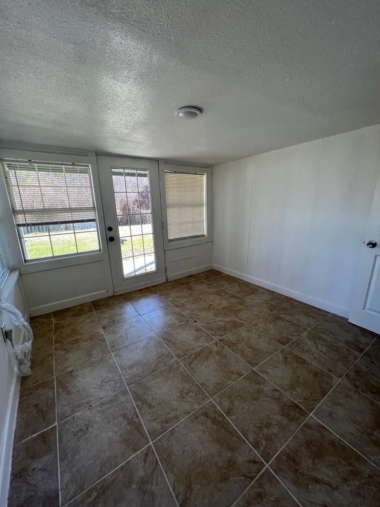 1272 Pecan Street, Unit B Clute, TX 77531 - Photo 5 of 10 an empty room with windows