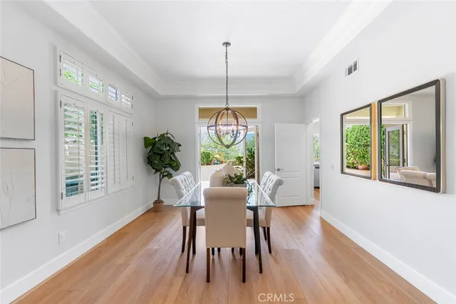 a view of a dining room with furniture chandelier and wooden floor