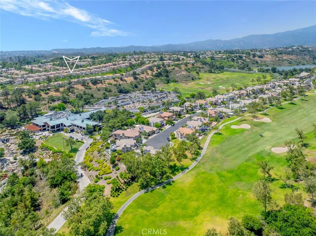 a living room with furniture a chandelier and a large window