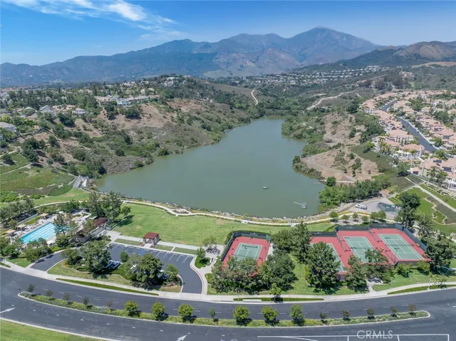 a kitchen that has a sink a table and chairs in it
