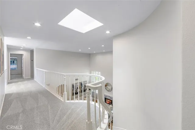 a spacious bedroom with a bed and a chandelier