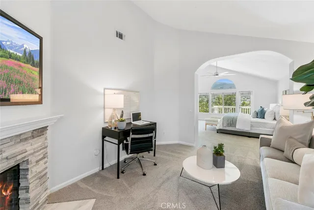 a view of a hallway with a dining table & a window