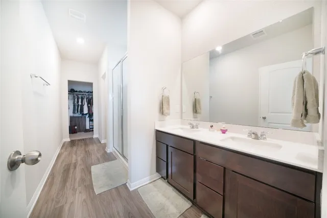 a bathroom with a double vanity sink and mirror