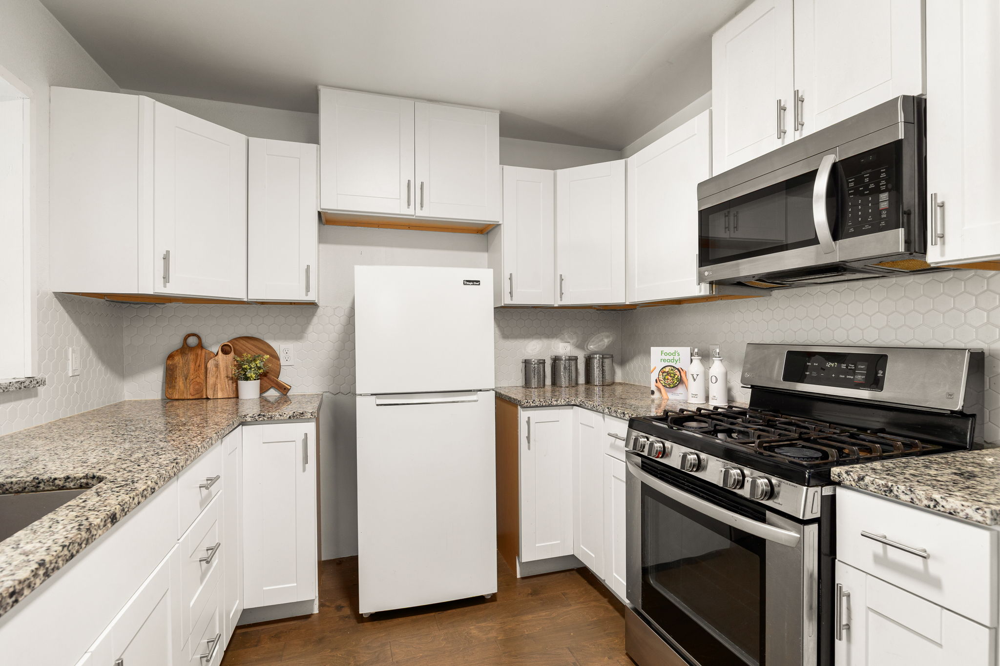 11800 Oak Haven Road Austin, TX 78753 - Photo 11 of 37 a kitchen with granite countertop white cabinets and stainless steel appliances