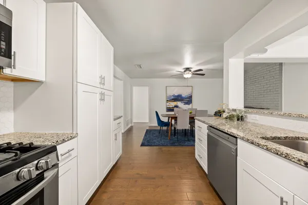 a kitchen with a sink and a stove top oven