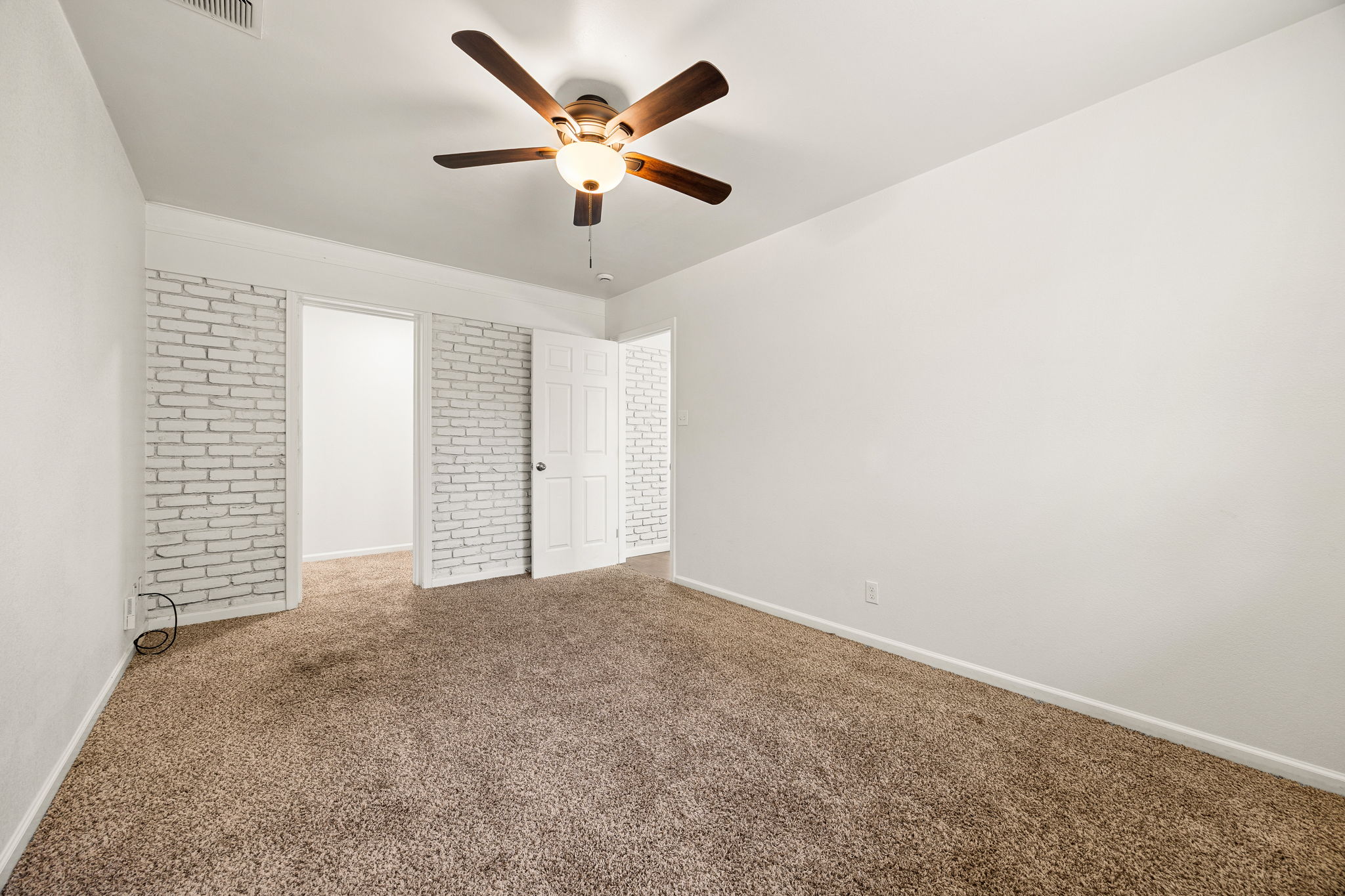 11800 Oak Haven Road Austin, TX 78753 - Photo 22 of 37 an empty room with a chandelier fan and windows