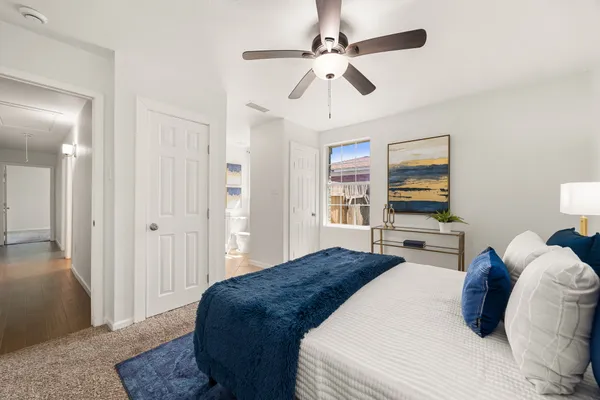 a bedroom with a large bed and a chandelier