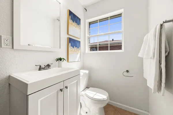 a bathroom with a sink toilet and mirror