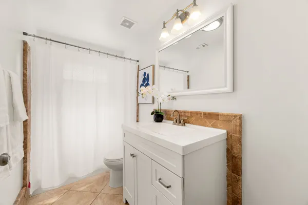 a bathroom with a sink vanity and a mirror