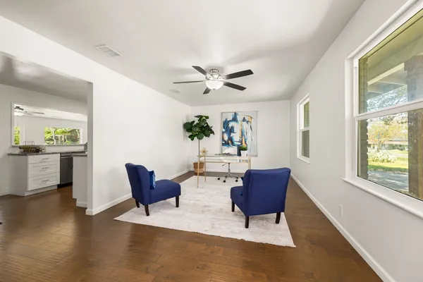 a living room with furniture and a large window