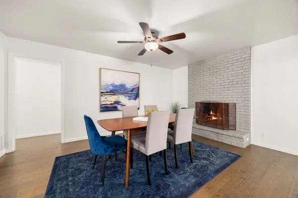 a view of a dining room with furniture and wooden floor