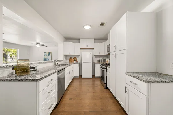 a large kitchen with kitchen island granite countertop lots of counter top space and refrigerator