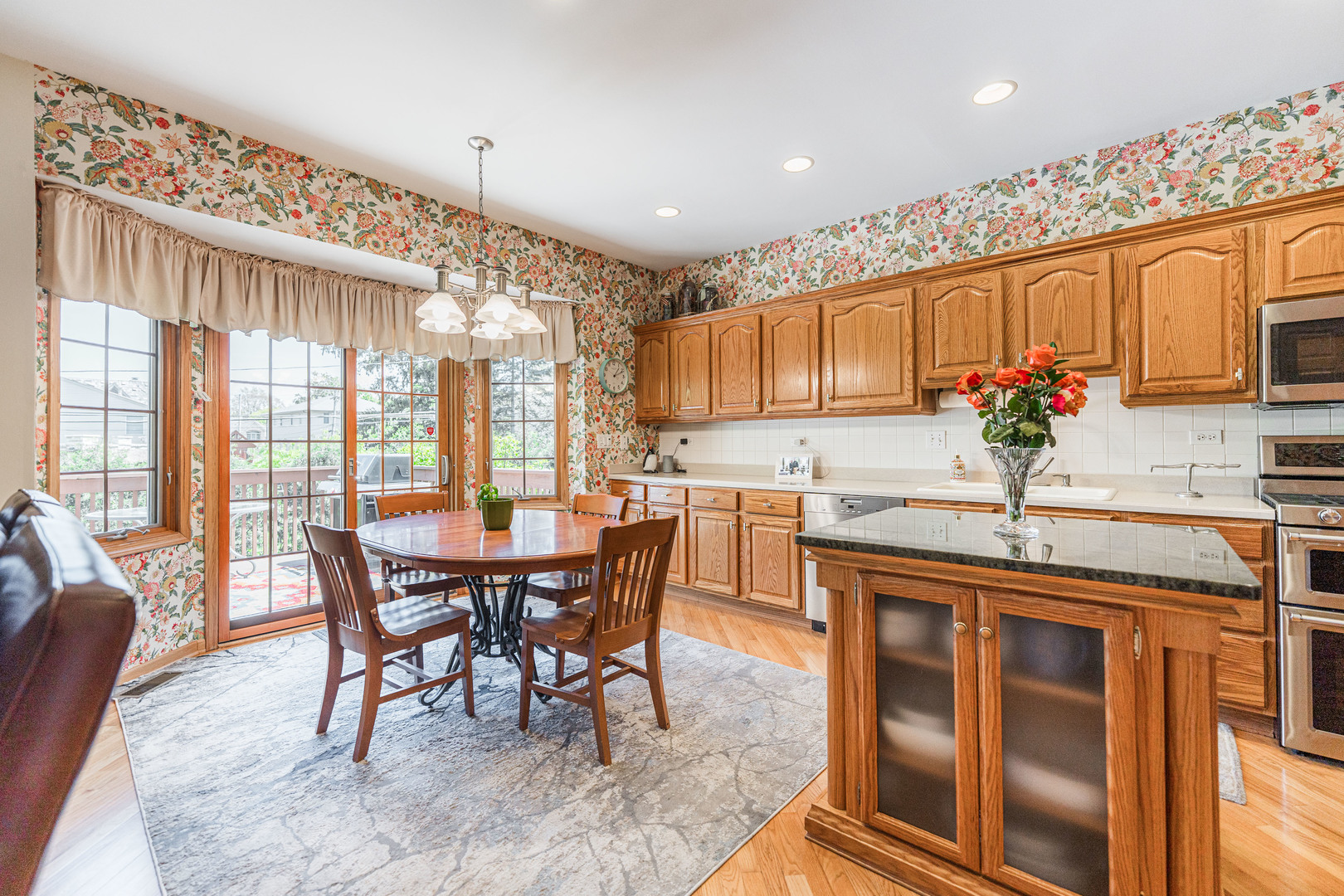 1607 Park Ridge Point Park Ridge, IL 60068 - Photo 6 of 41 a kitchen with kitchen island granite countertop a table chairs sink and cabinets