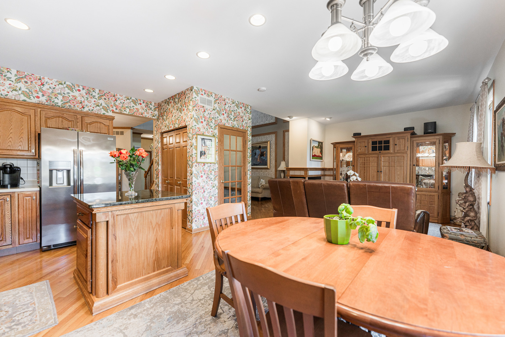 1607 Park Ridge Point Park Ridge, IL 60068 - Photo 8 of 41 a kitchen with stainless steel appliances kitchen island granite countertop a table chairs and a refrigerator