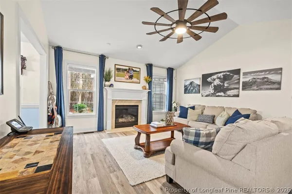 a living room with furniture and a fireplace