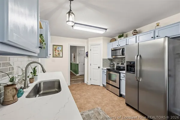 a kitchen with refrigerator a sink and cabinets