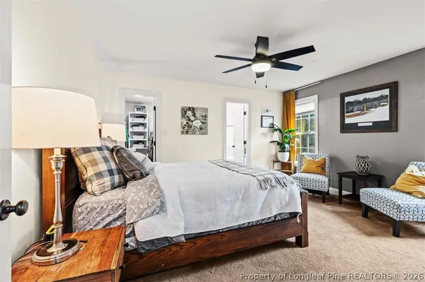 a bedroom with a bed couch and window