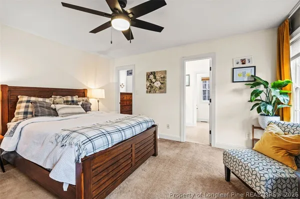 a bedroom with a bed and ceiling fan