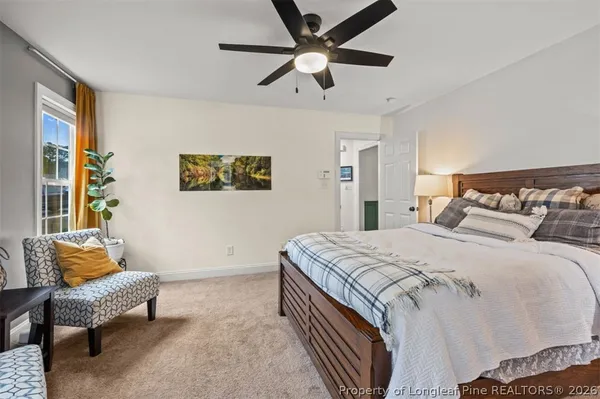 a bedroom with a bed and a couch