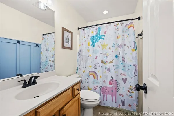 a bathroom with a sink and mirror with toilet