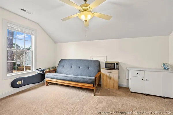 a bedroom with furniture and a window