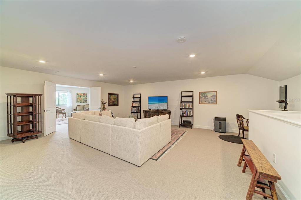 16341 Hidden Oak Loop Lakewood Ranch, FL 34211 - Photo 41 of 76 a living room with furniture and a flat screen tv