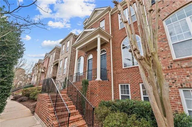 a view of a brick house with a large window