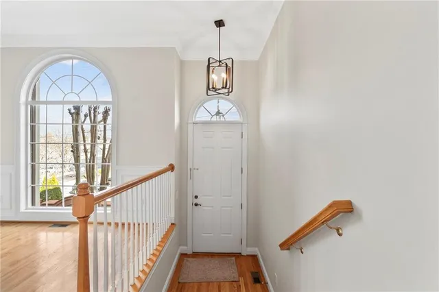 a kitchen with stainless steel appliances granite countertop a stove a sink dishwasher and a microwave oven with wooden floor