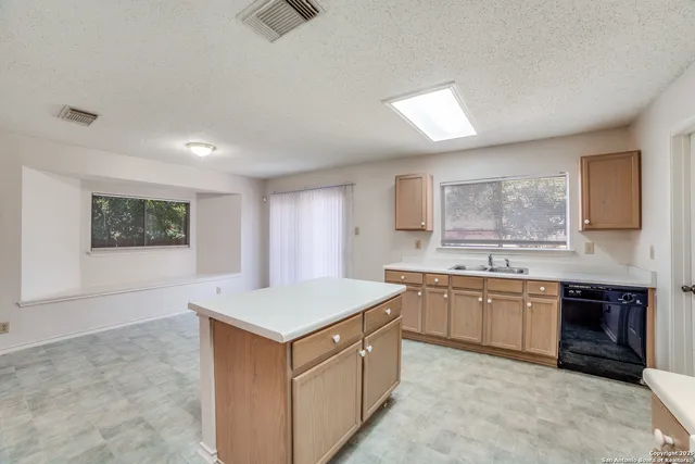 a kitchen with a stove a sink and a refrigerator