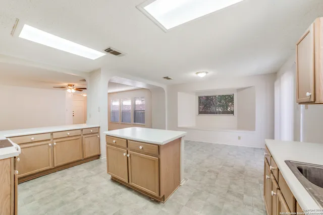 a kitchen with a stove a sink and a refrigerator