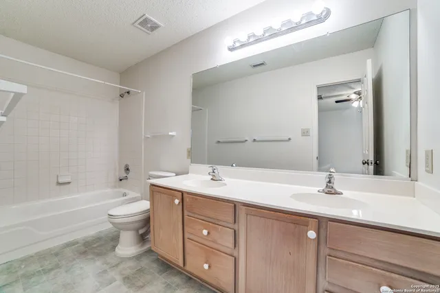a bathroom with a sink double vanity granite tub and a mirror