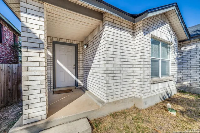 a view of a porch with a door and wooden floor