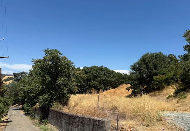 a view of a yard covered with snow in front of house