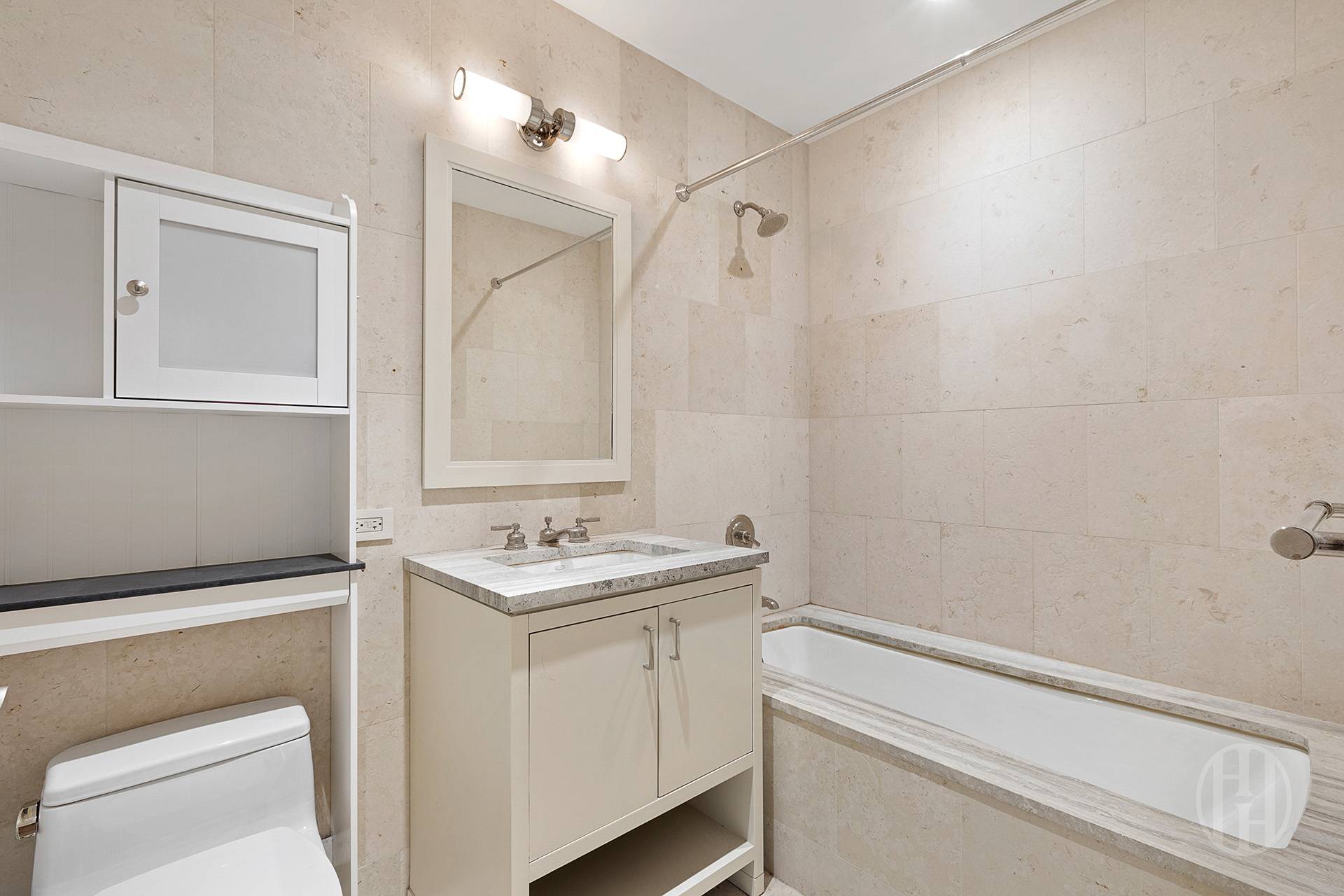 100 Riverside Boulevard, Unit 8J Manhattan, NY 10069 - Photo 4 of 10 a bathroom with a sink a toilet and a mirror