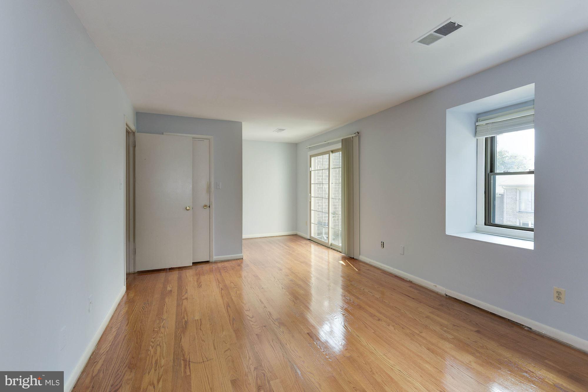 2148 Military Road Arlington, VA 22207 - Photo 11 of 28 a view of an empty room with wooden floor and a window