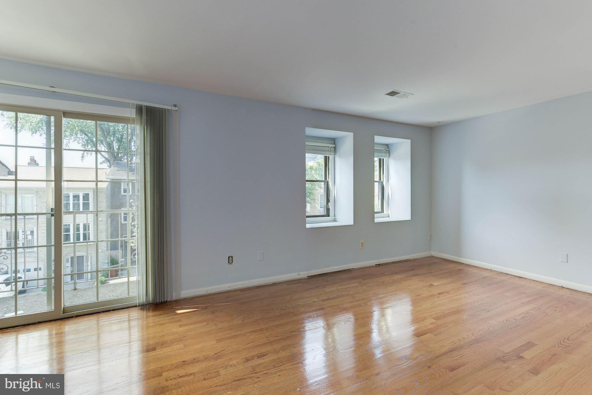 2148 Military Road Arlington, VA 22207 - Photo 4 of 28 a view of an empty room with wooden floor and a window